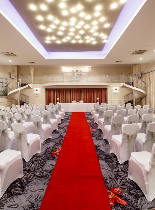 The Balmoral Suite at Mercure Bewdley The Heath Hotel set up for a wedding ceremony, red carpet aisle